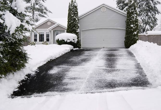 Driveway cleared of snow in front of a Madison, WI home