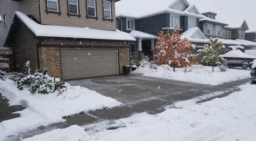 Residential driveway cleared during a winter snowfall