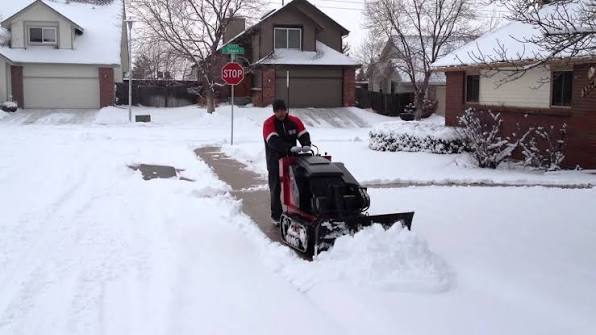 Clearing snow from a sidewalk in a Madison, WI neighborhood